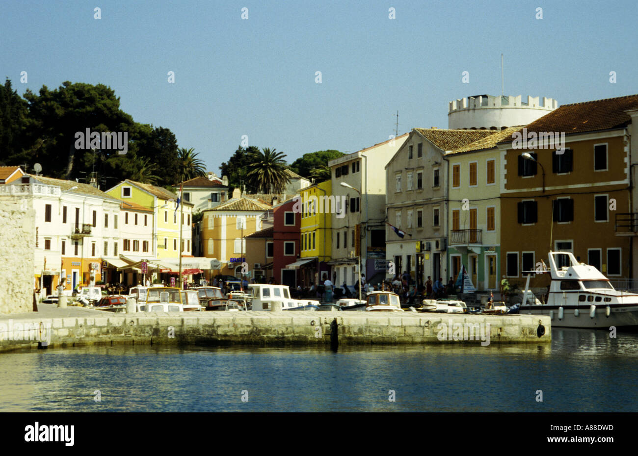 View of the charming town of Veli Losinj with its coloured houses and crenulated castle from the sea, Losinj, Croatia Stock Photo