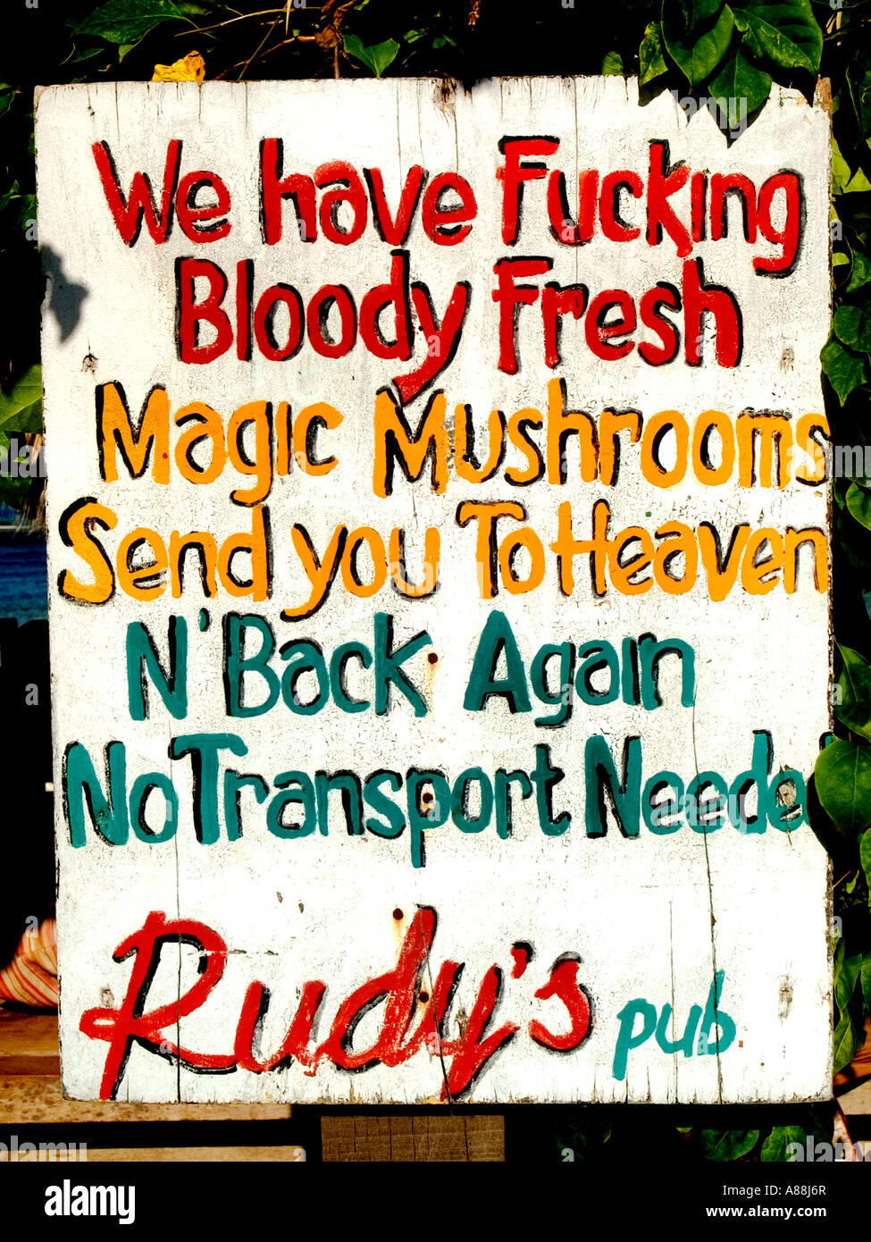 Hand painted sign outside of Rudy's pub advertising magic mushrooms for sale,Gili Trawangan,Indonesia. Stock Photo