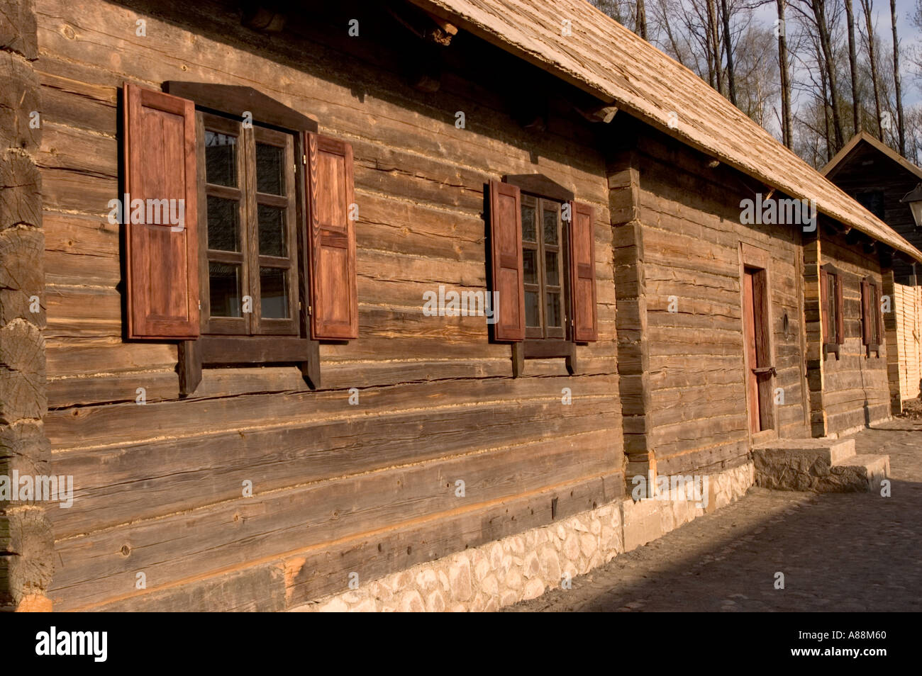 Traditional wooden log building with shutters and stone foundation at ...