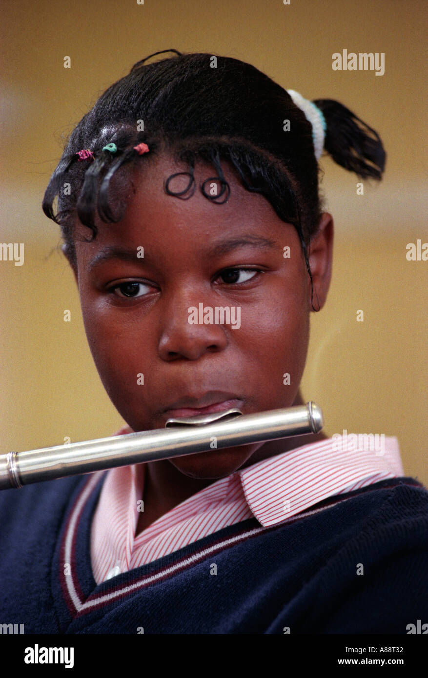 Secondary school pupil in music class playing the flute Southwark