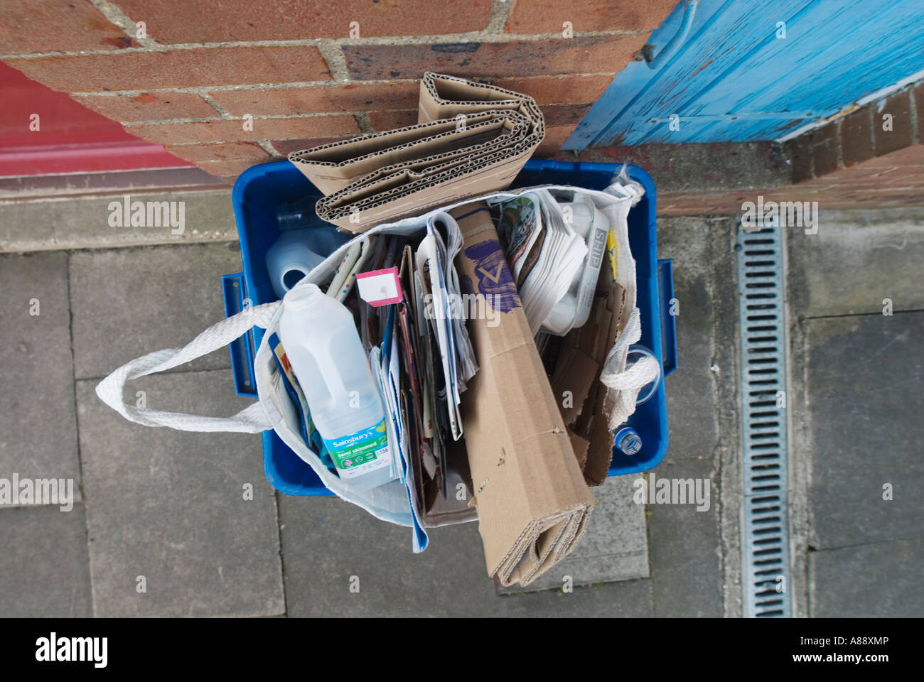 Recycling box full of cardboard awaiting collection from refuse