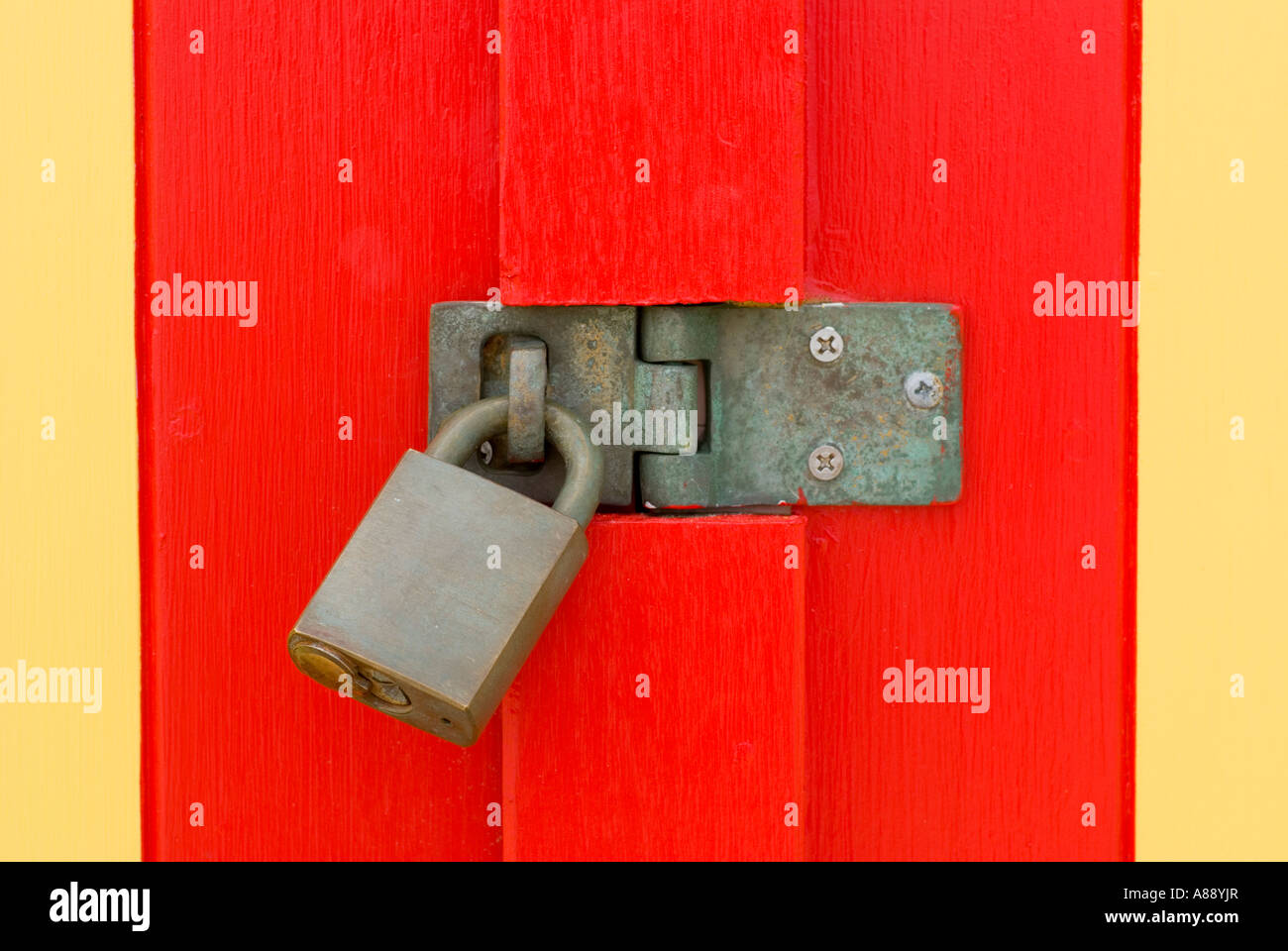Padlock on brightly painted door Stock Photo Alamy