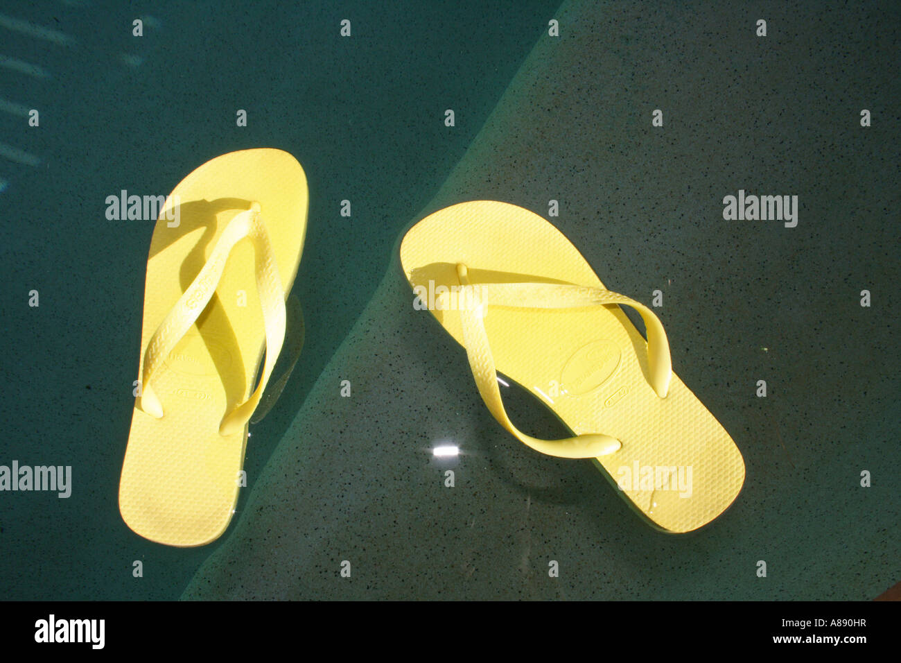 A PAIR OF THONGS BY A POOL BDA10600 Stock Photo - Alamy