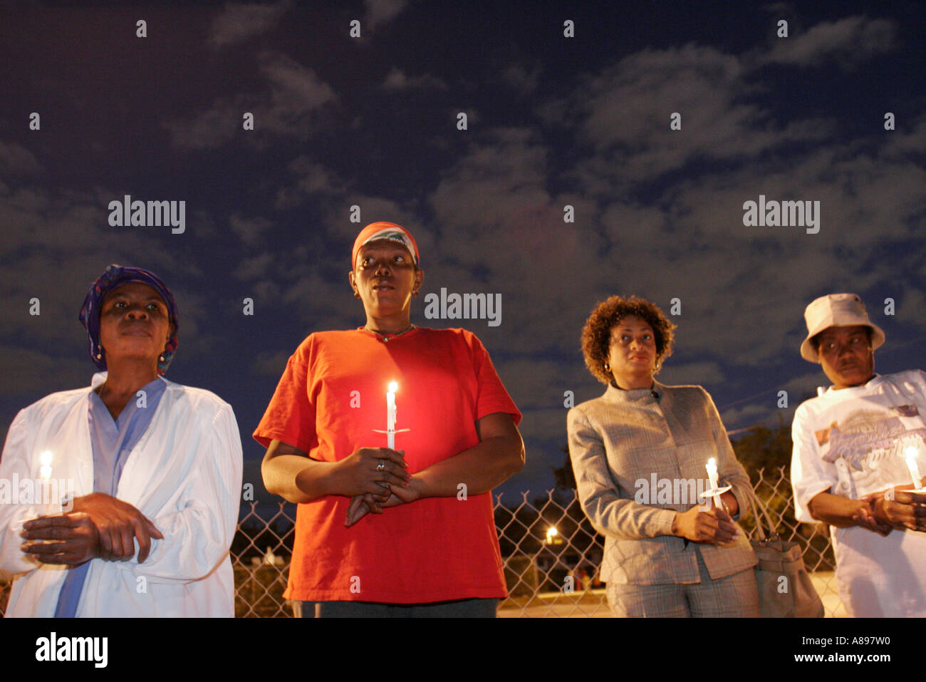 Miami Florida,Little Haiti,Freedom Garden,pray for Haiti peace vigil,Black Blacks African Africans ethnic minority,women,candle,candlelight,fire,flame Stock Photo