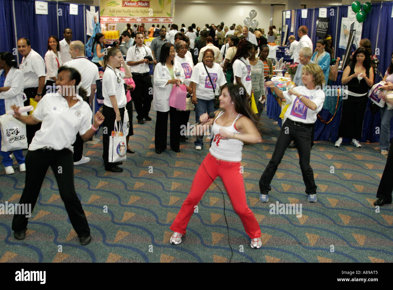 Miami Florida,National Woman's Heart Day Health Fair,Hispanic woman female women,leads group aerobic exercise,Zumba,FL060228072 Stock Photo