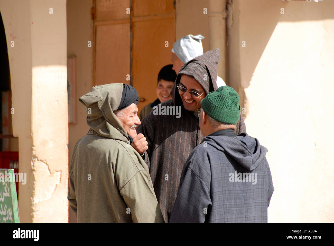 Traditionally dressed men stand around talking Irhern Morocco Stock Photo