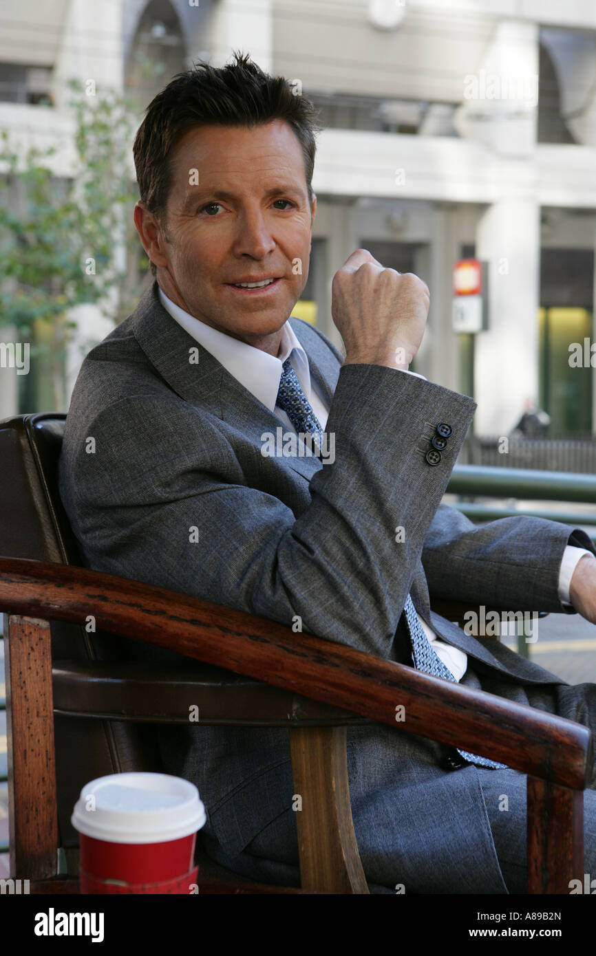 Business man sitting in a shoe shine chair Stock Photo Alamy