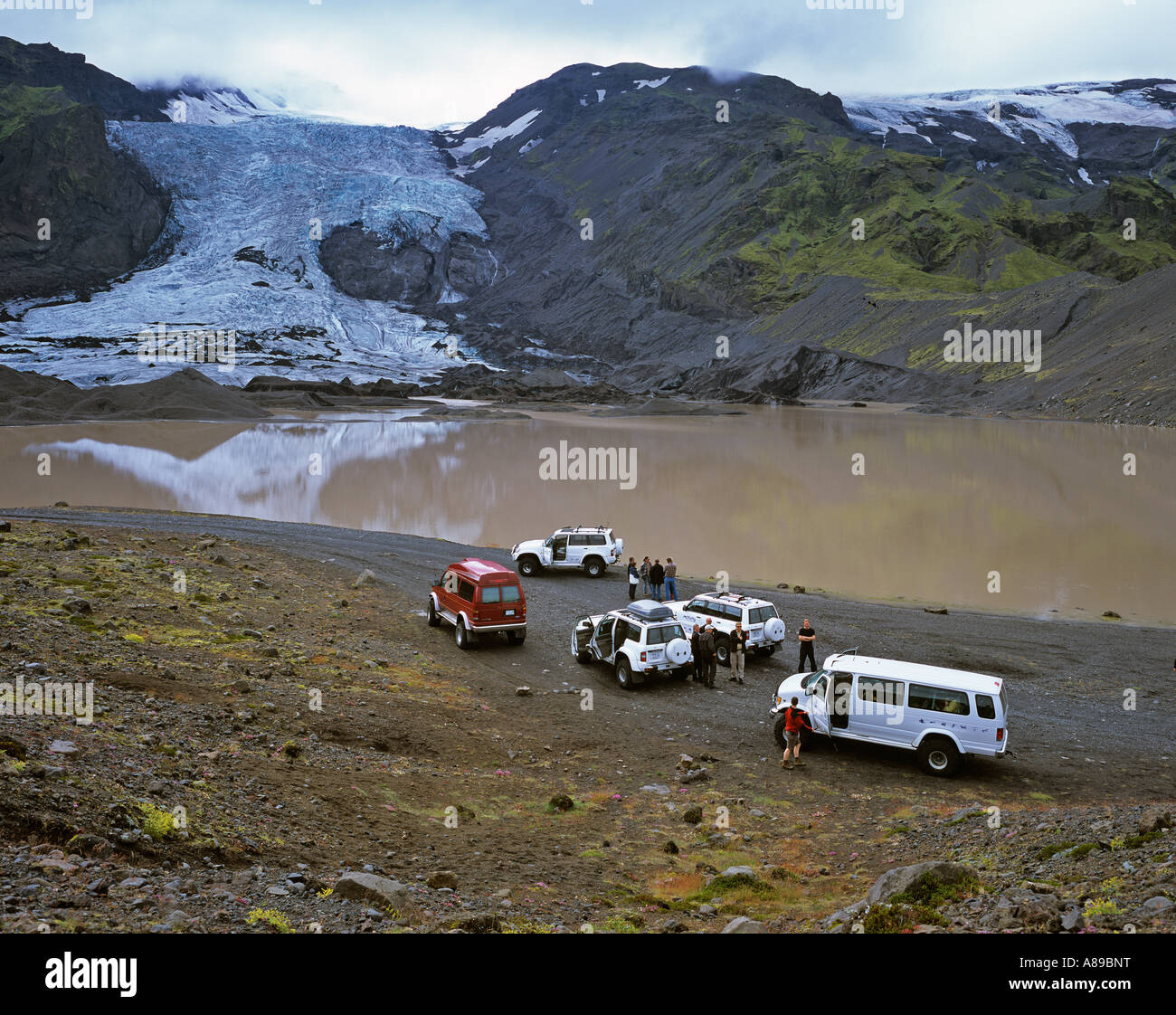 Four wheel drive cars and a glacier lake behind the Gigjoekull glacier, Thorsmoerk, Iceland Stock Photo