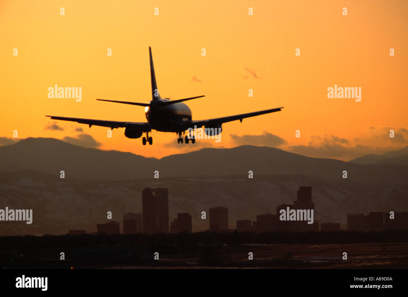 A Boeing 737 landing at twilight at Stapleton International Airport in Denver Colorado Stock Photo