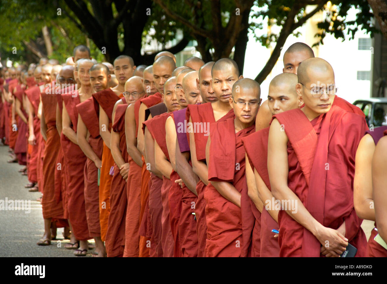 Many Buddhist monks stand in line Mahasi Meditation Centre Yangon Stock