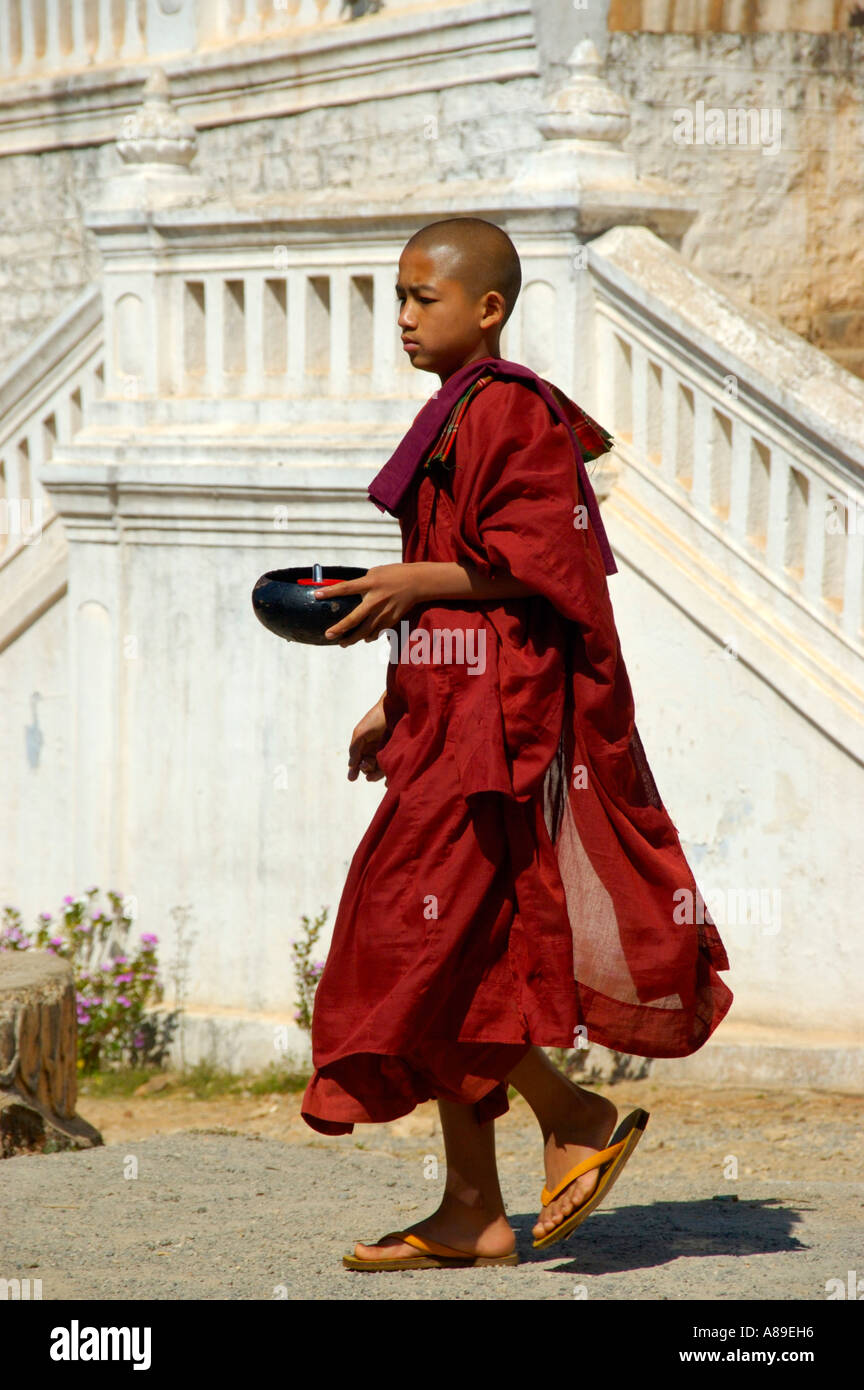 Novice in red robe with a begging bowl Maing Thauk Forest Monastery Shan State Burma Stock Photo