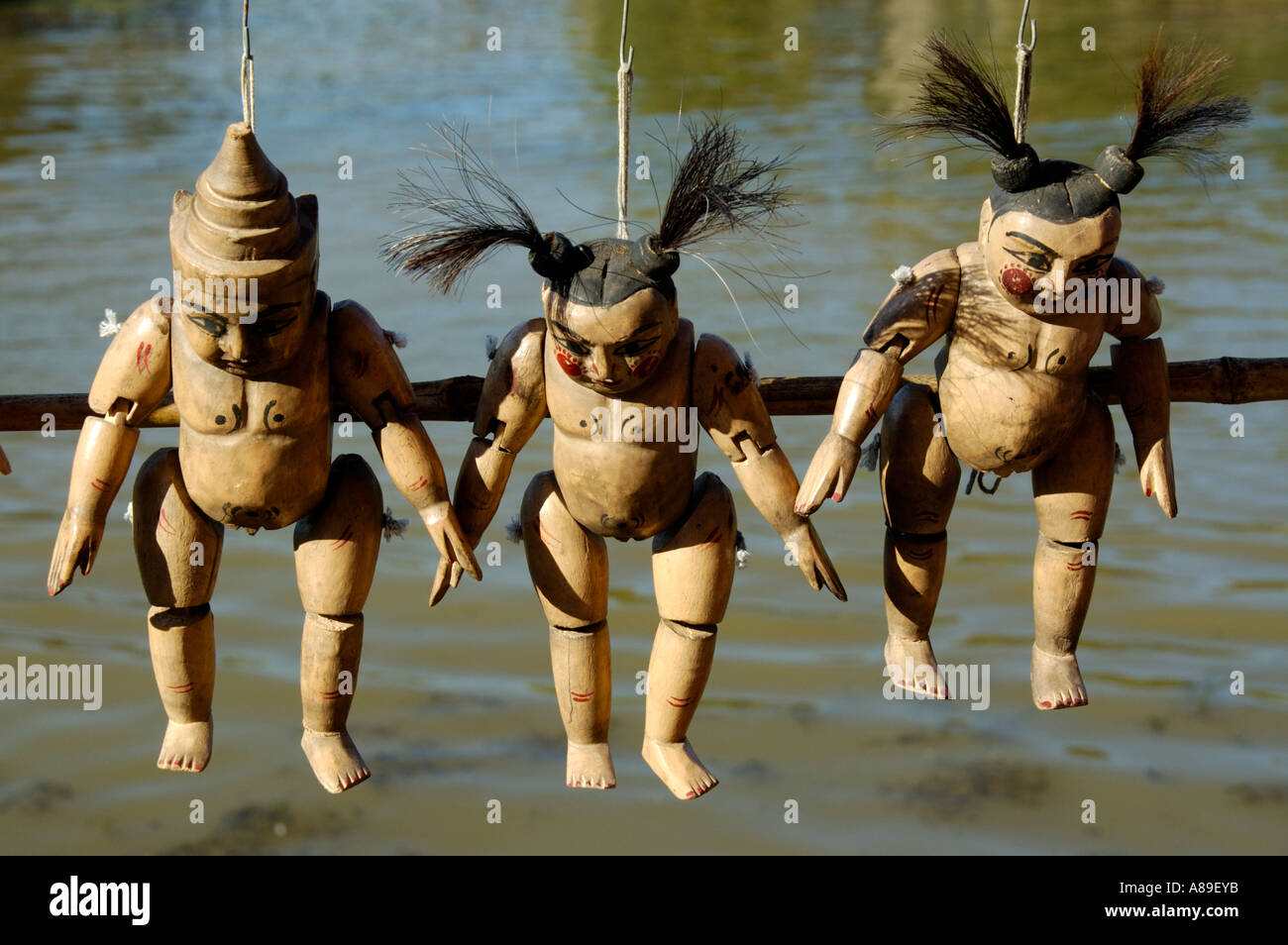 Three wooden puppets above water Inle Lake Shan State Burma Stock Photo
