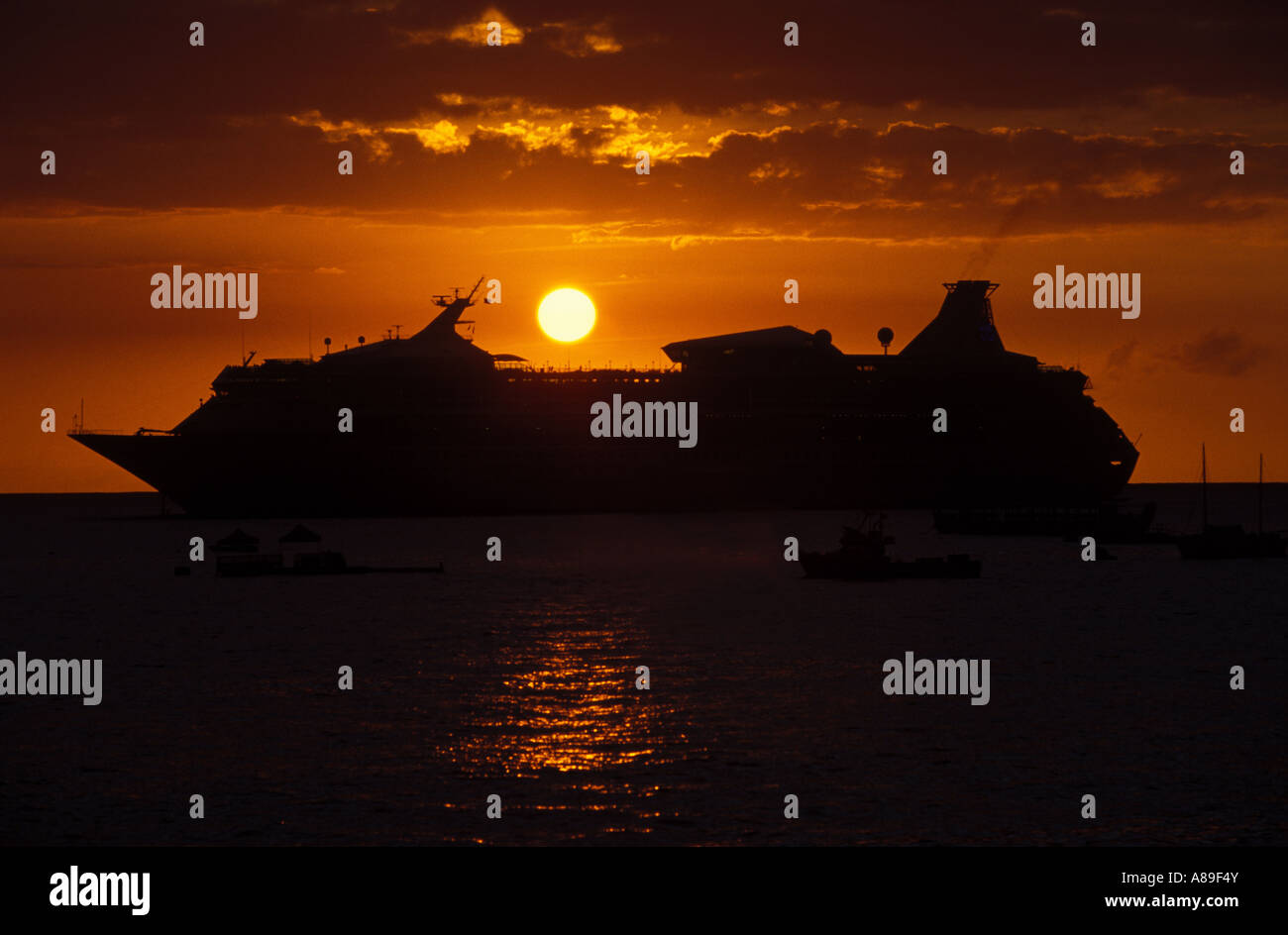 Sundown on the sea with a cruise liner in front Stock Photo