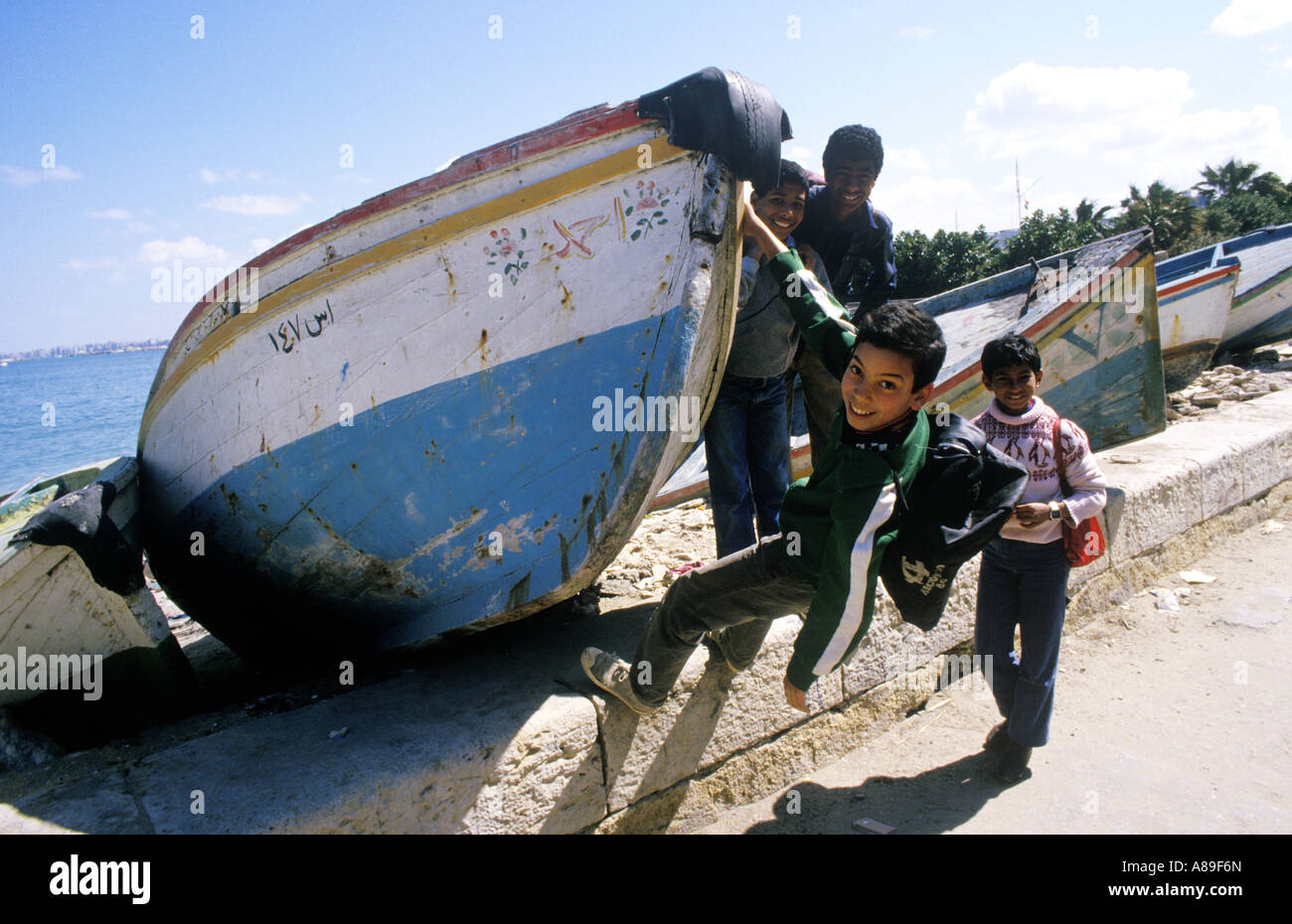 Egypt children playing with a fishing boat , Alexandria, Egypt Stock Photo