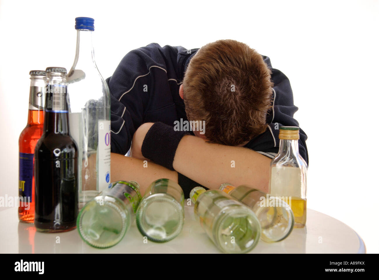 Teenager getting drunk with alcopops and beer Stock Photo
