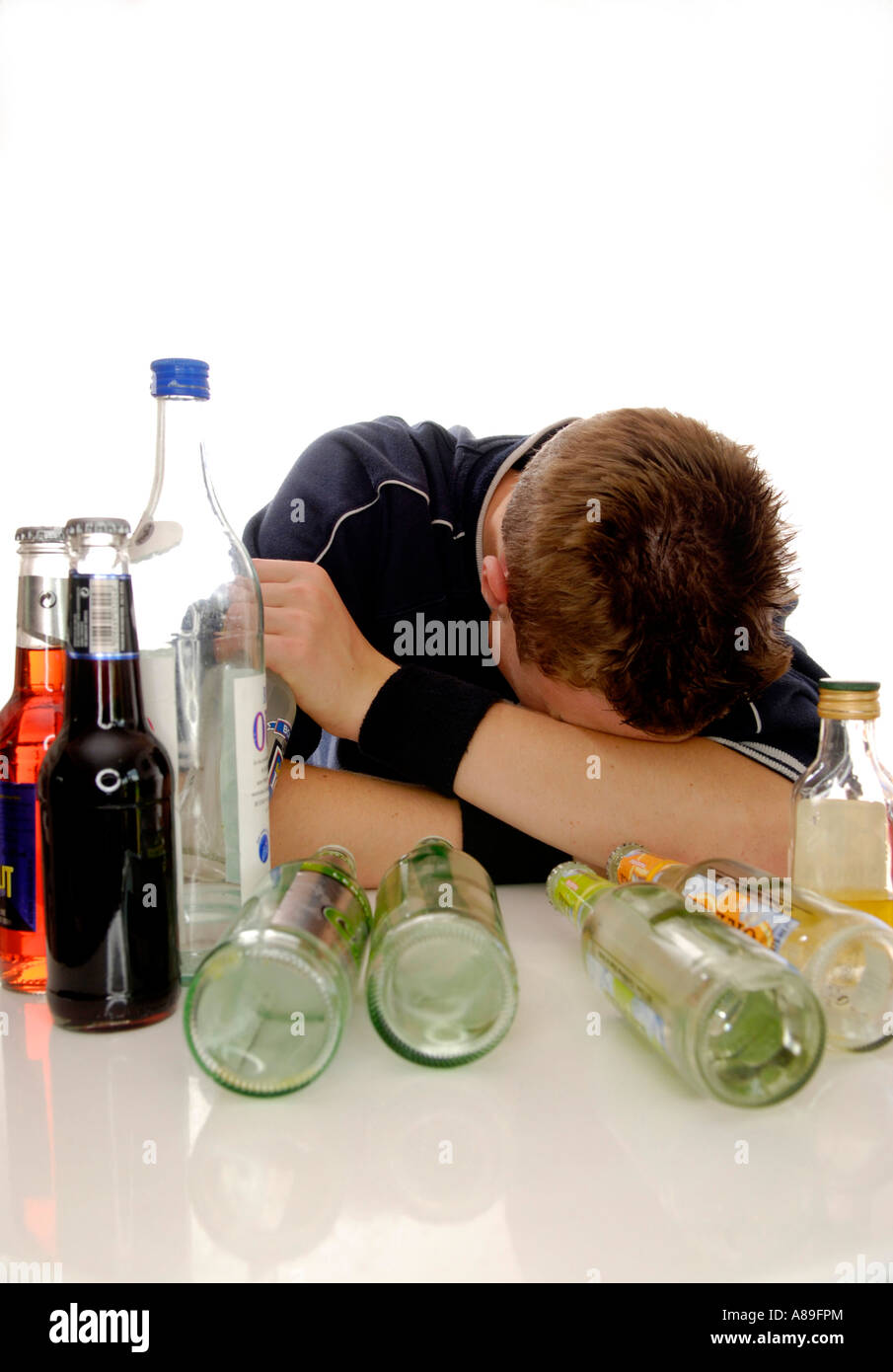 Teenager getting drunk with alcopops and beer Stock Photo