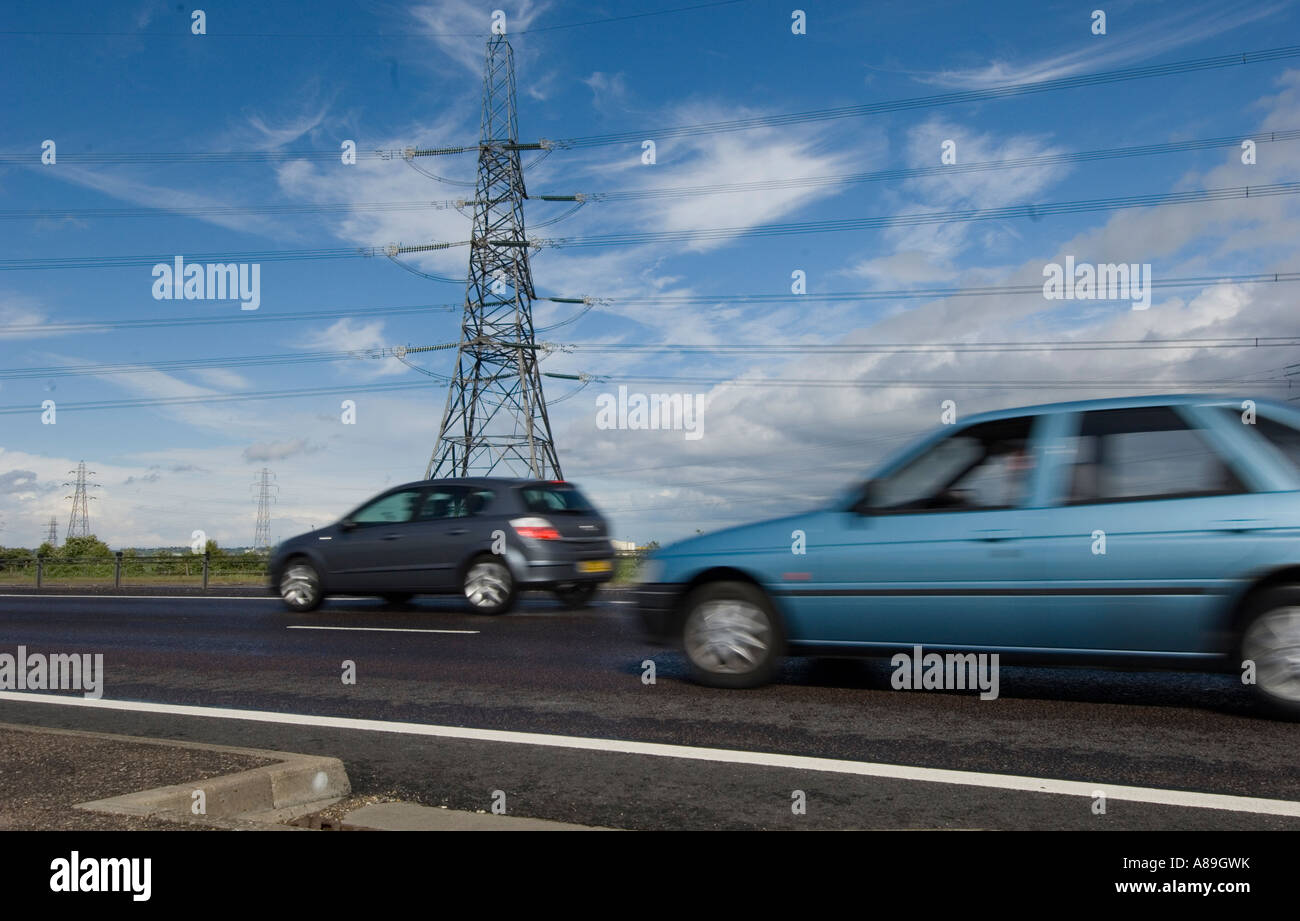 Busy road and electricity pylons Stock Photo