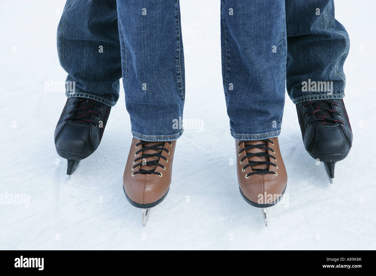 Two people wearing jeans on ice skates Stock Photo Alamy