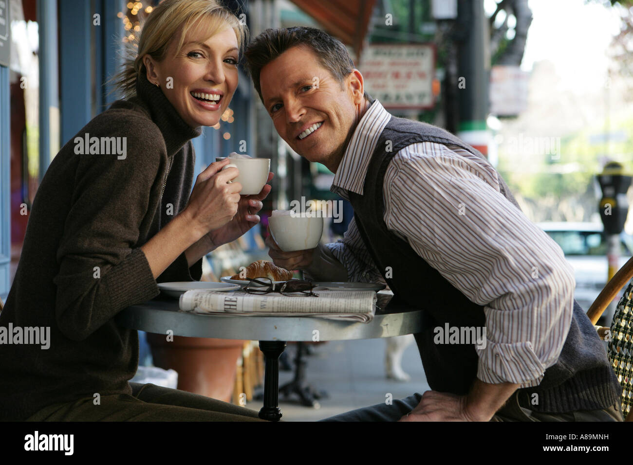 Mature couple at an outdoor cafe looking at camera Stock Photo