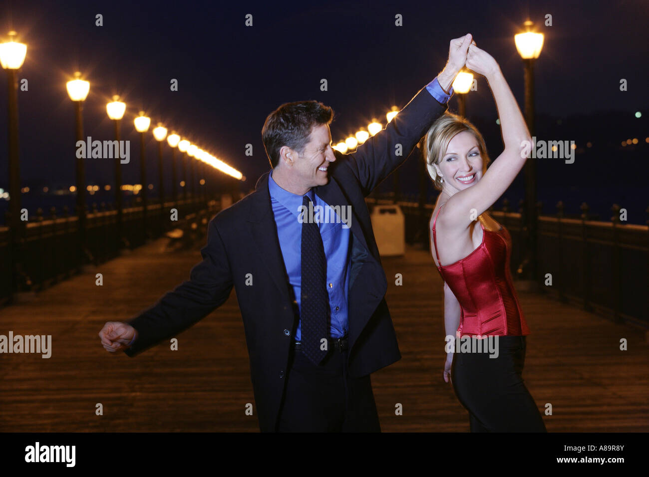 Mature couple dancing outdoors Stock Photo