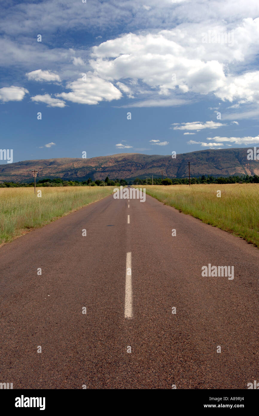 A seconary road and the Magaliesberg mountains in South Africa's North West Province. Stock Photo