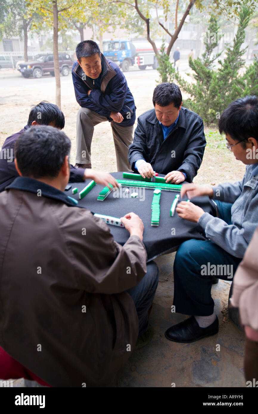 CHINA BEIJING Chinese men playing mahjong a traditional Chinese game of skill and luck using tiles Stock Photo