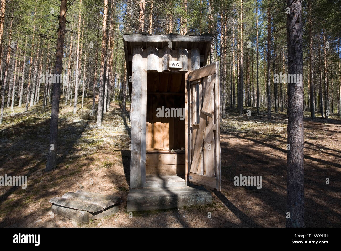 wooden outhouse in forest, Finland Europe Stock Photo