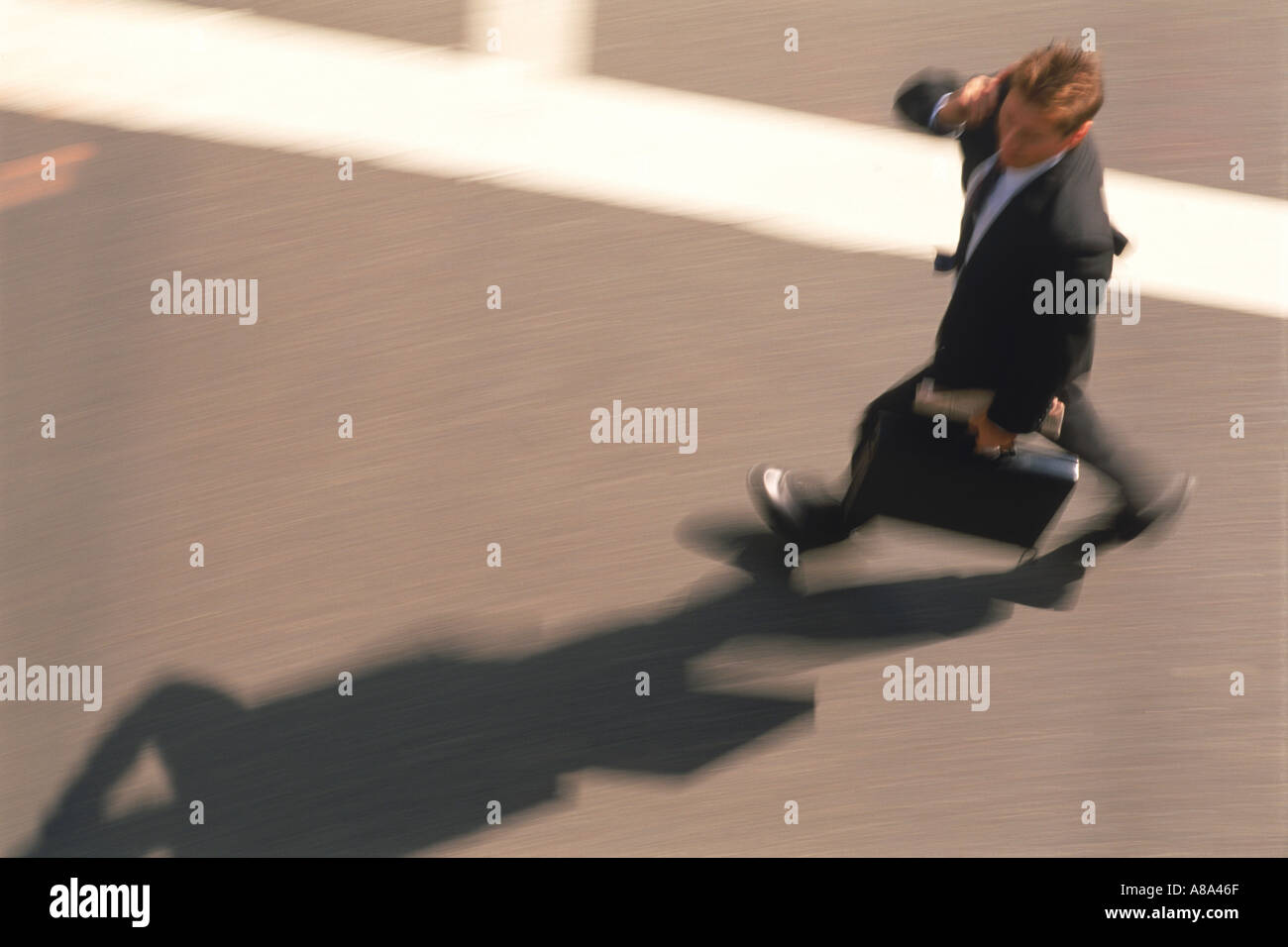 Businessman with briefcase in crosswalk Stock Photo