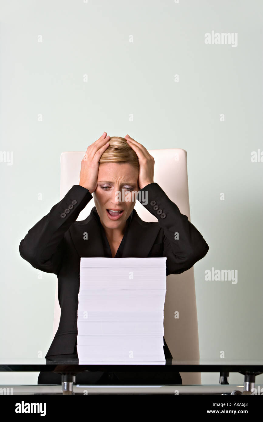 Stressed woman with paperwork Stock Photo - Alamy