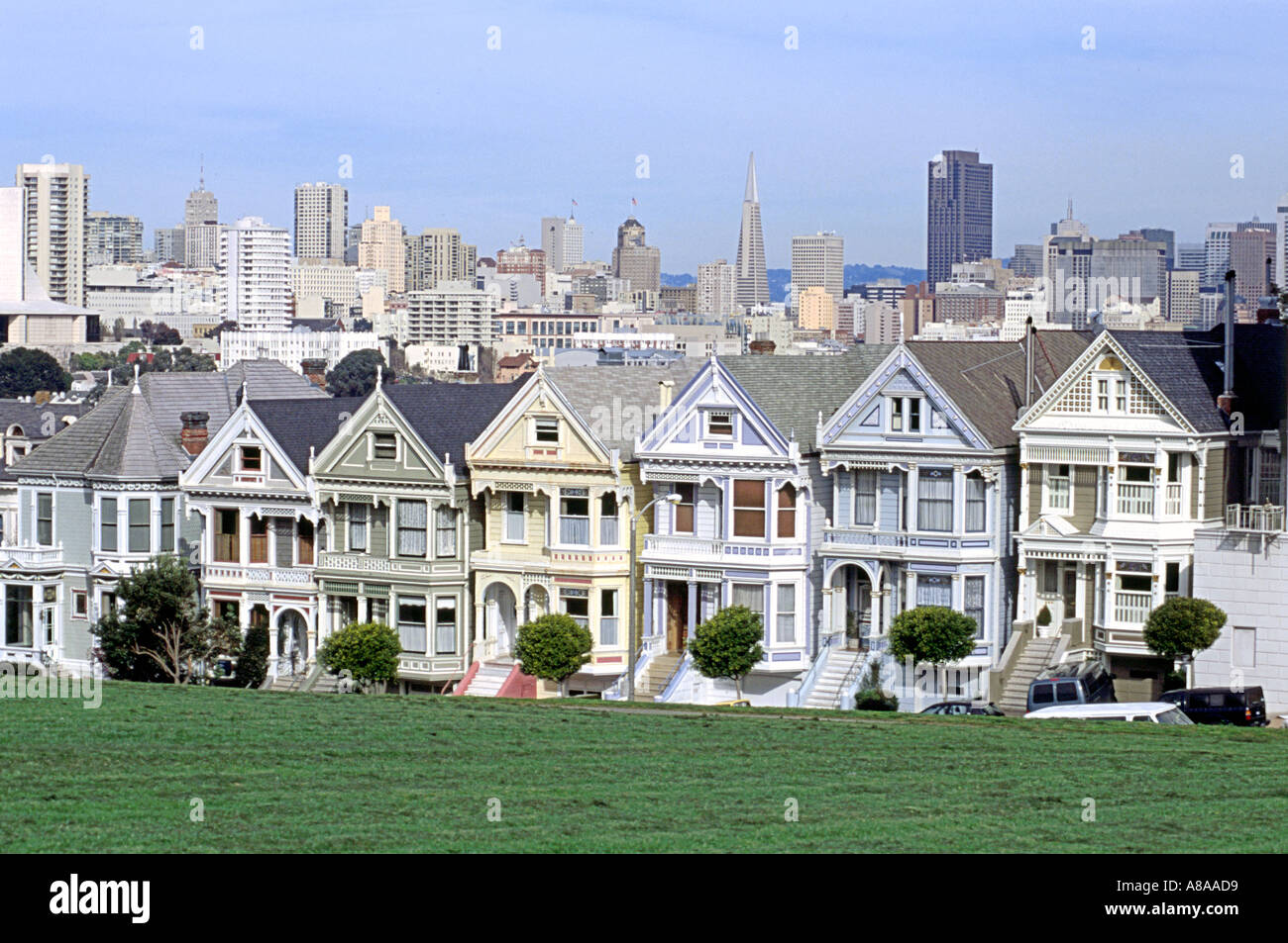 'Postcard row', a row of Victorian houses also known as The Painted Ladies in Alamo Square in the suburbs of San Francisco. Stock Photo