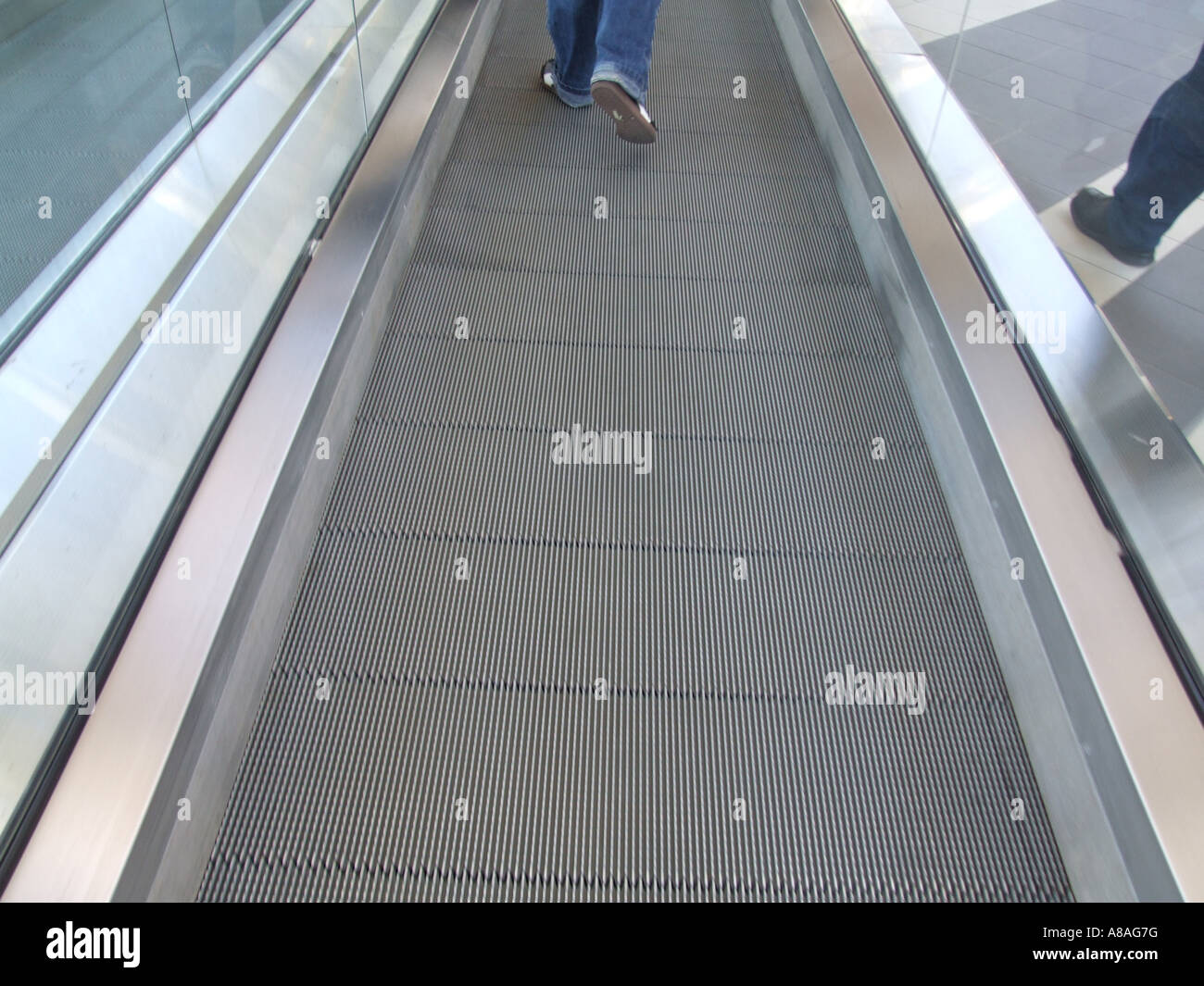 person walking on escalator Stock Photo Alamy