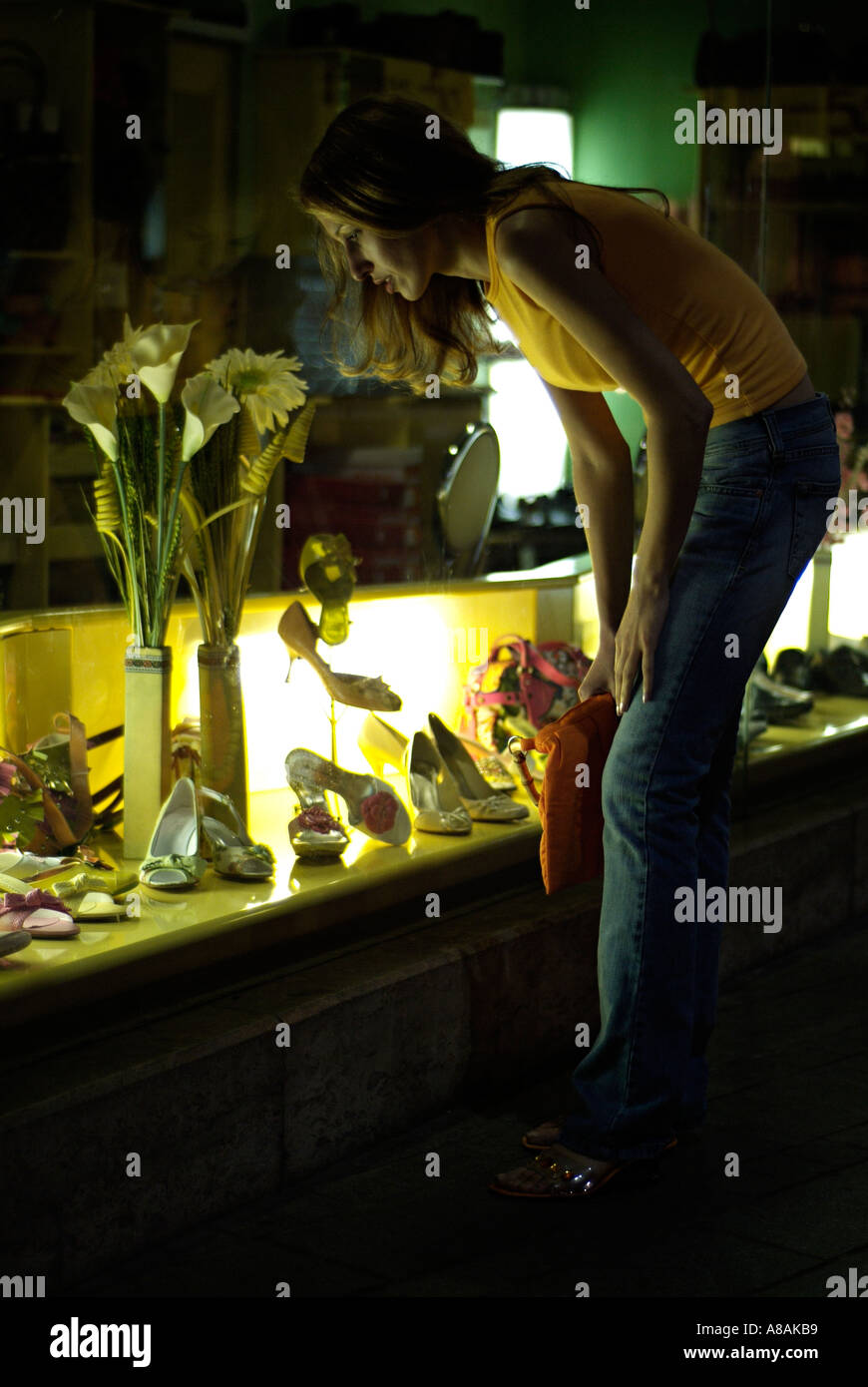 Young Woman Window Shopping at an Exclusive Fashion Boutique Stock Photo