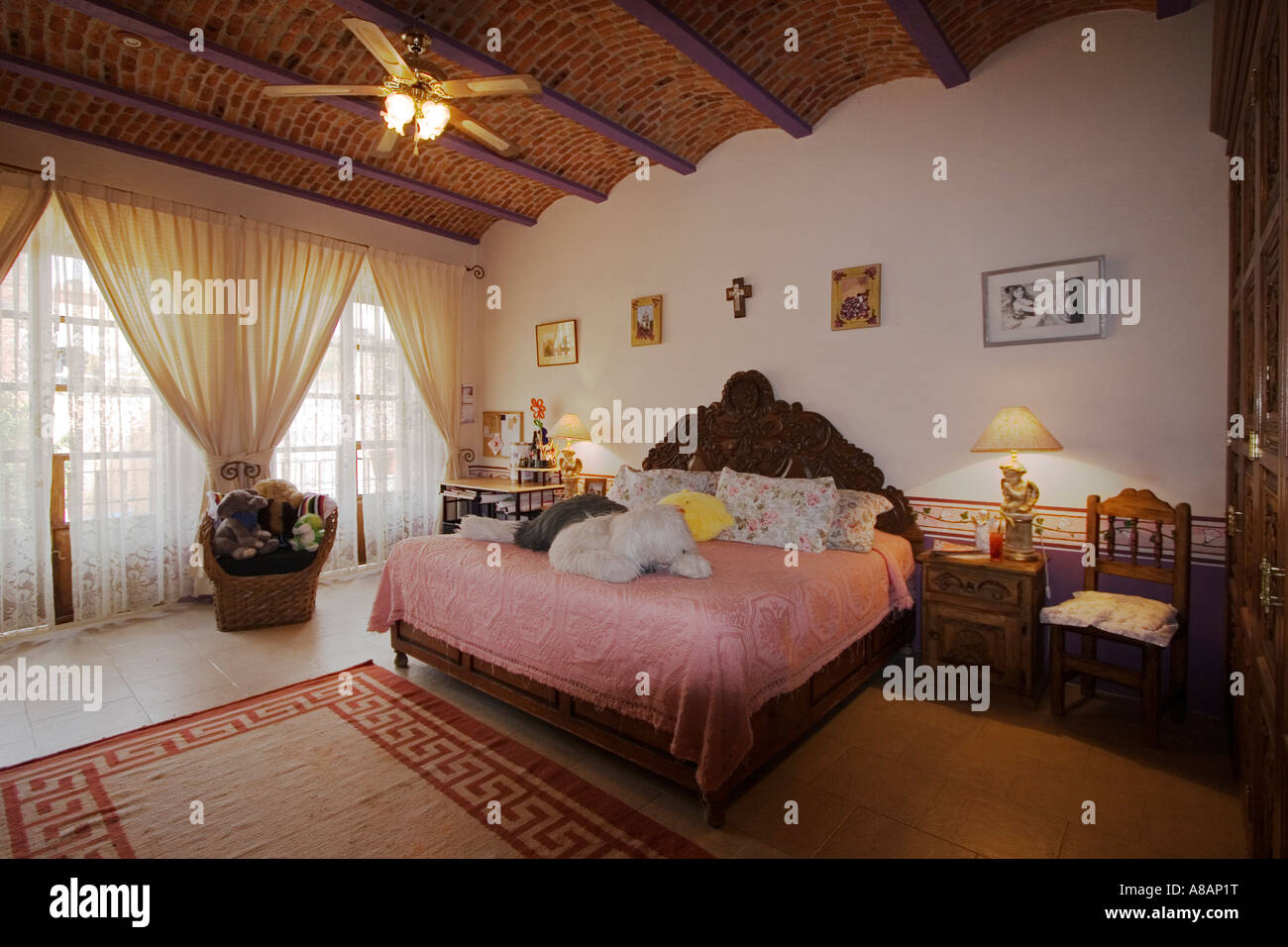 A hand carved WOODEN BED in a BEDROOM visited during the weekly HOUSE