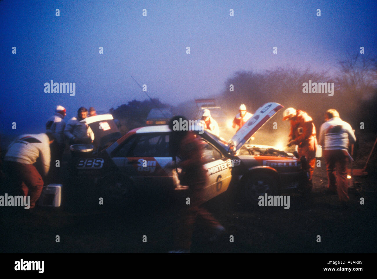 Service crew at dawn working on an Audi Quattro Rally Car 1983 Stock Photo