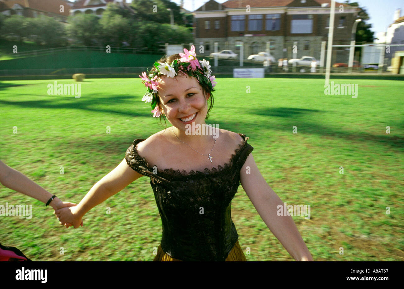 Smiling young girl dances in Medieval clothes at festival at Manly Sydney Australia Stock Photo