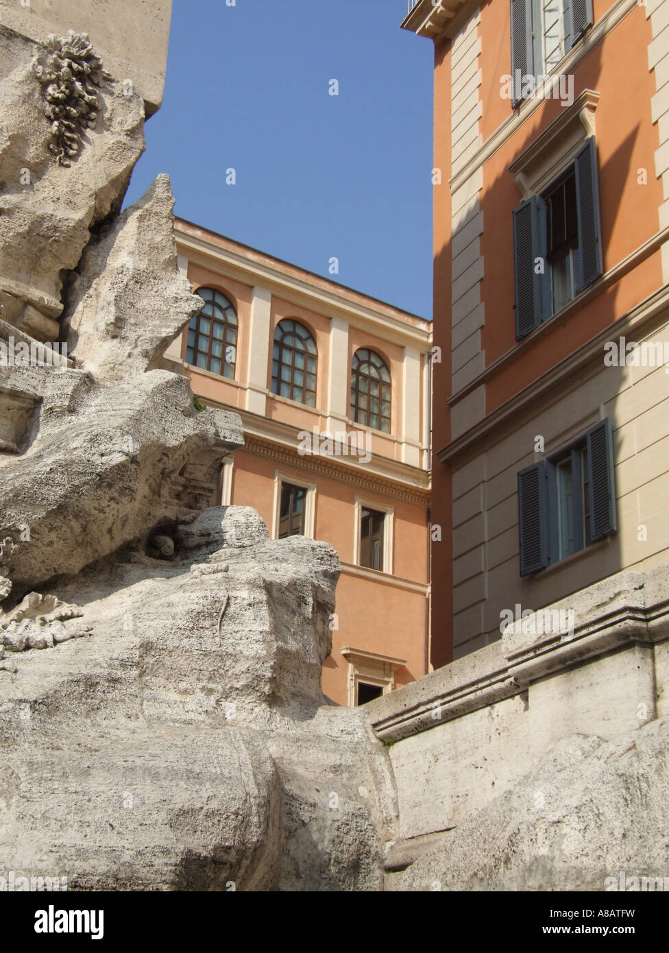 detail of rocks by trevi fountain monument and building in rome italy ...