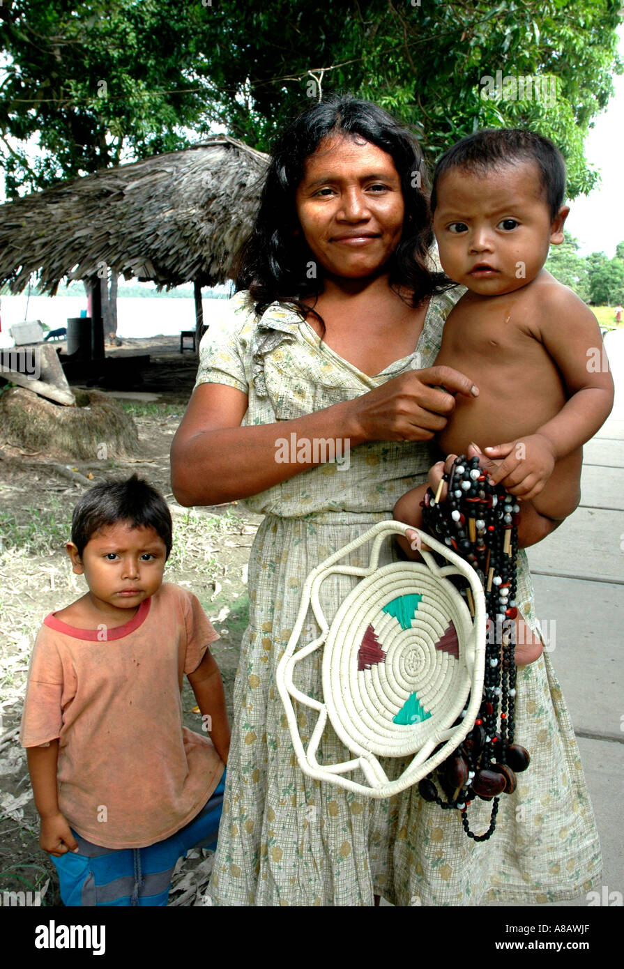 Warao woman with her children in Venezuela's Orinoco river delta Stock Photo