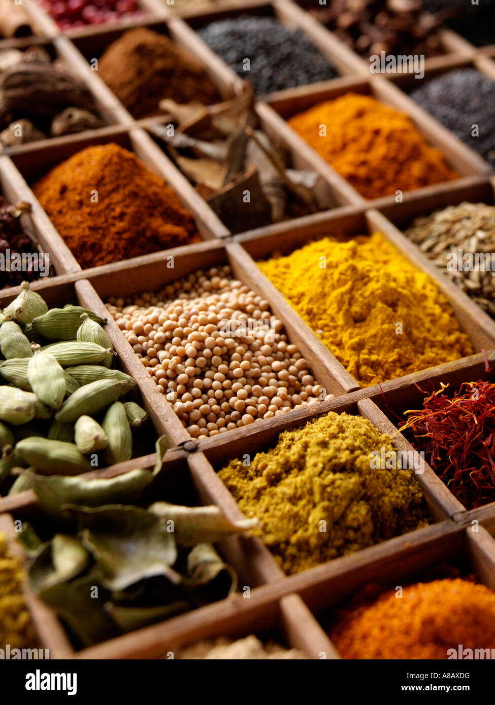 A variety of Indian spices in a wooden tray editorial food Stock Photo