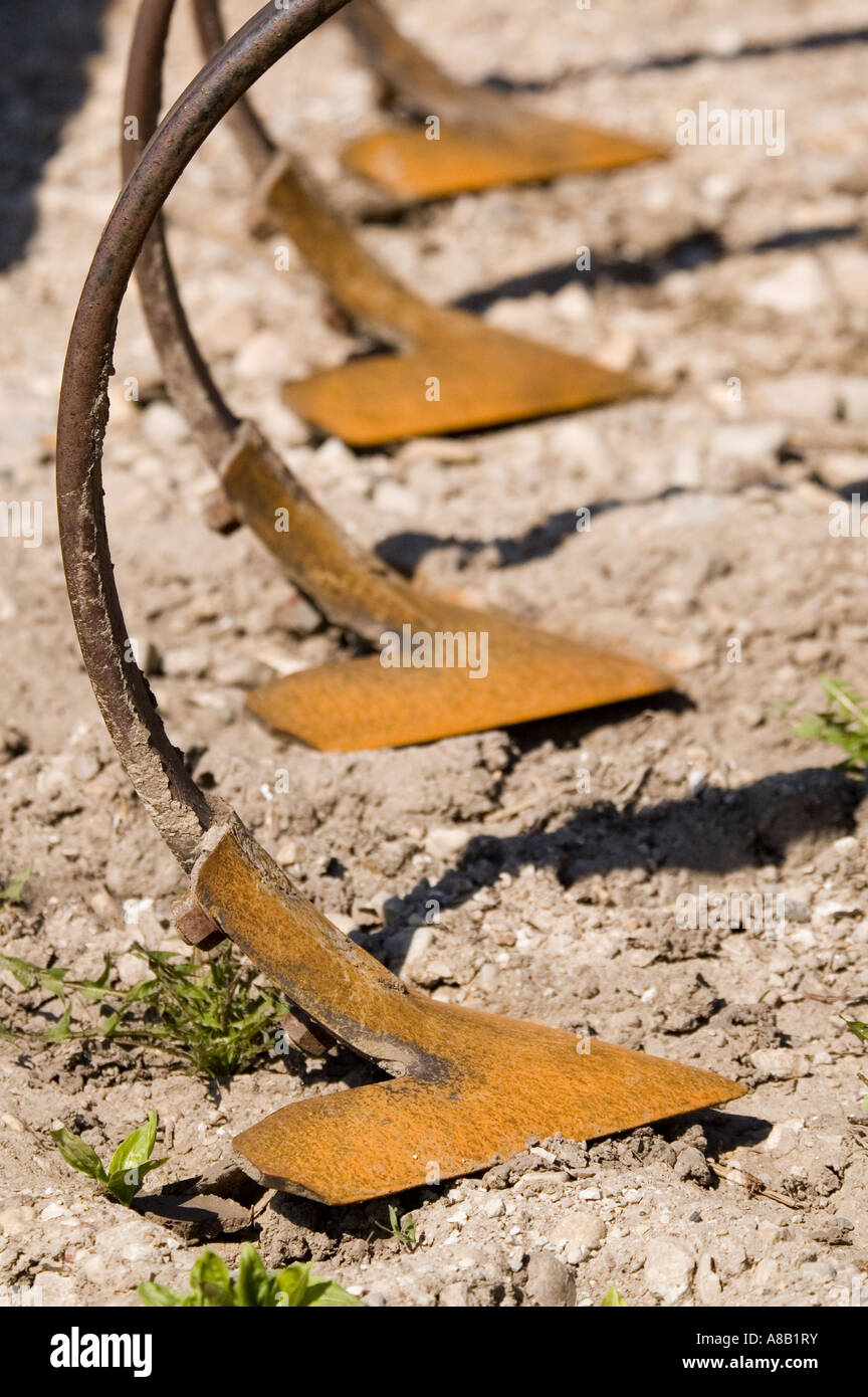 Rusting cultivator bits sit in the sun Stock Photo - Alamy