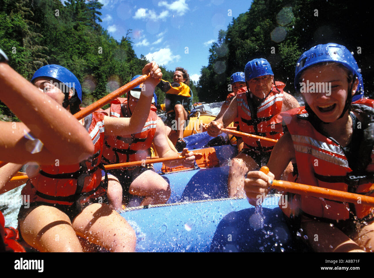 Hi action shot of a family white water rafting on the Penobscot River Maine USA Stock Photo