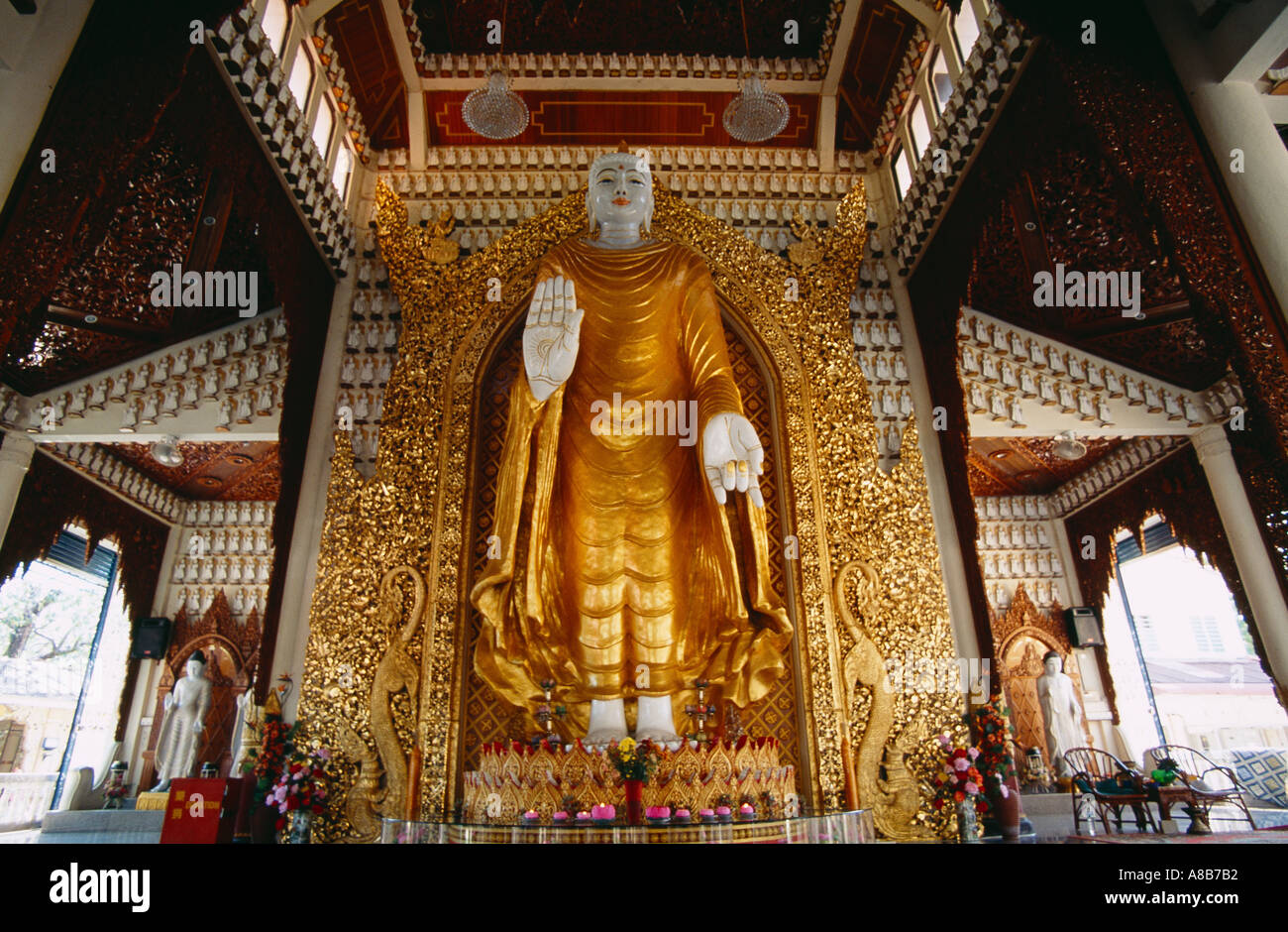 MALAYSIA Penang Island Georgetown Dharmikarama Burmese Temple Large Golden standing Buddha statue with palm raised facing out Stock Photo