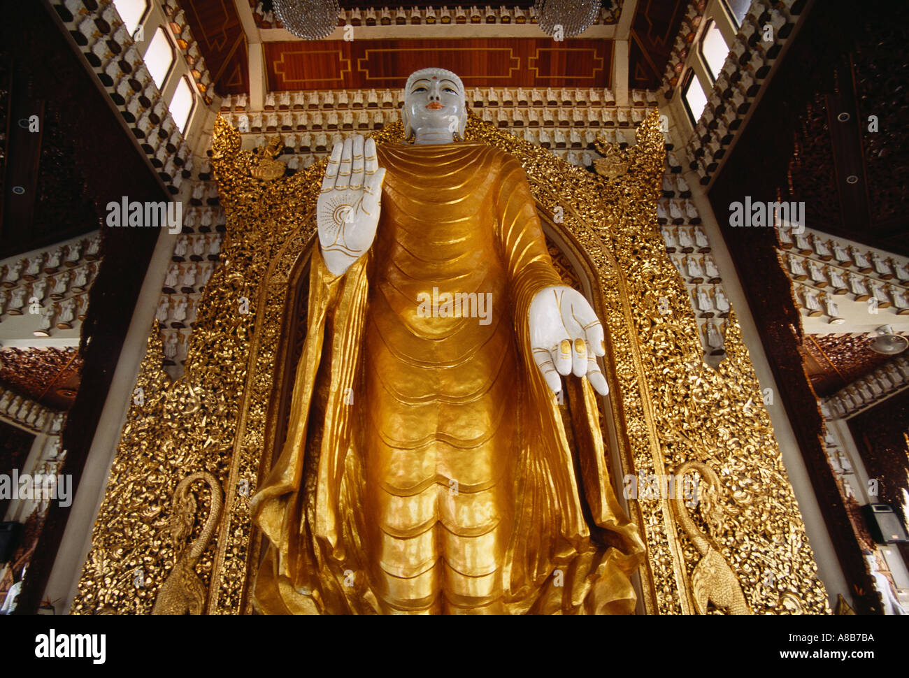 MALAYSIA Penang Island Georgetown Dharmikarama Burmese Temple Golden Standing Buddha hand raised palm out to ward off evil Stock Photo