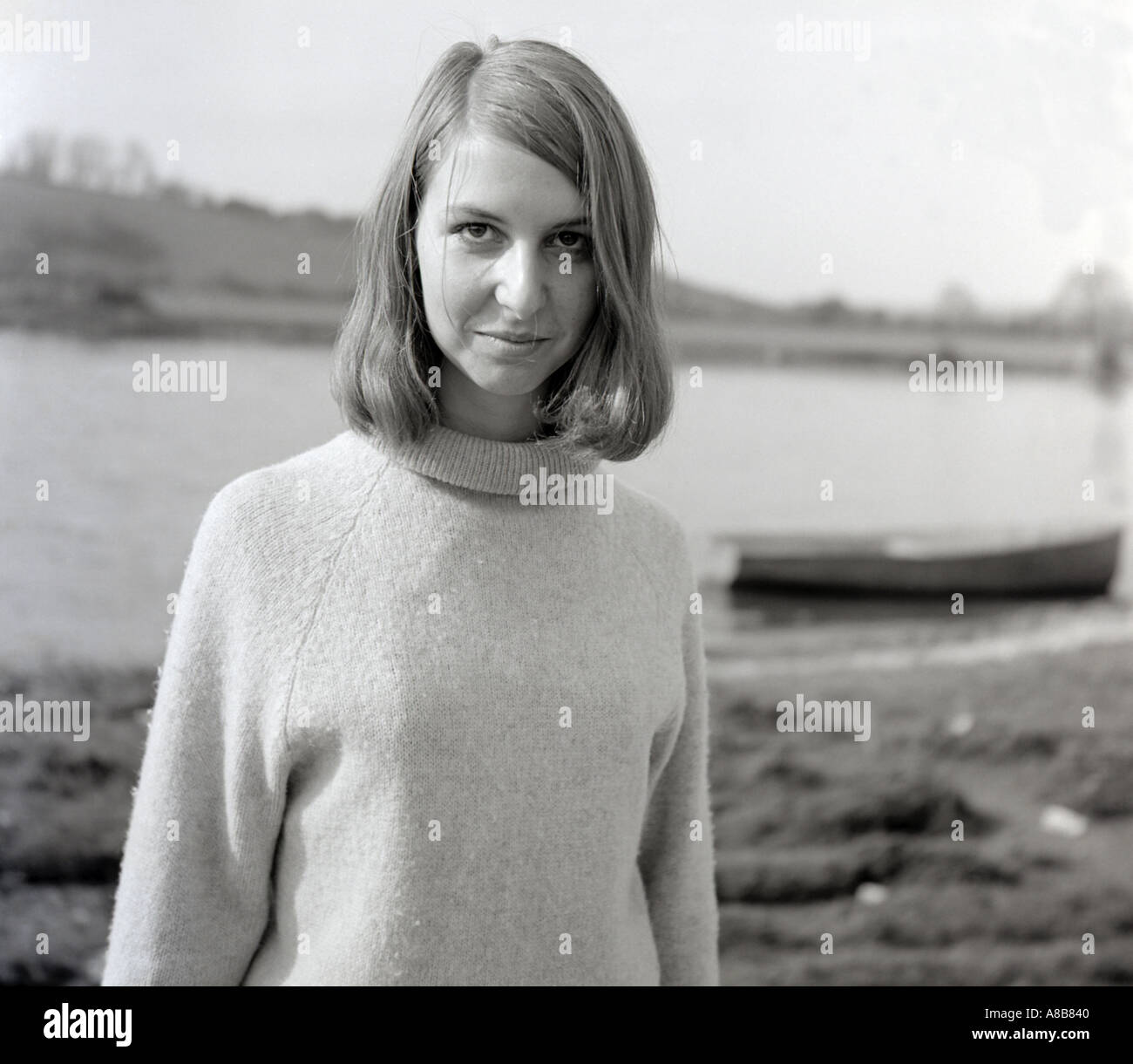 Black and white portrait of a young woman with a river in the ...