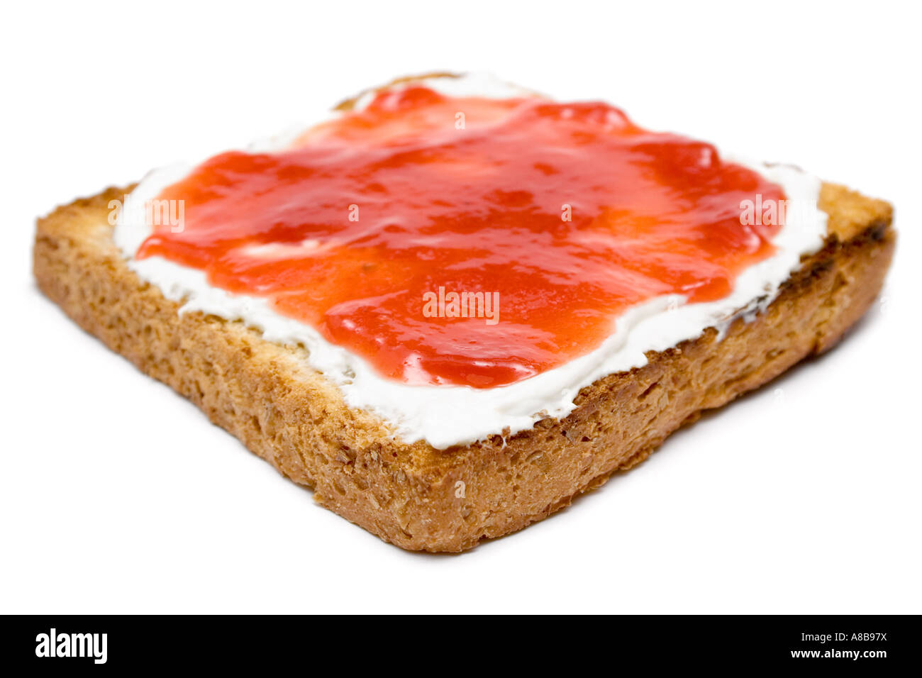 Butter and jam on a warm slice of bread Isolated on a white background Shallow depth of field  Stock Photo