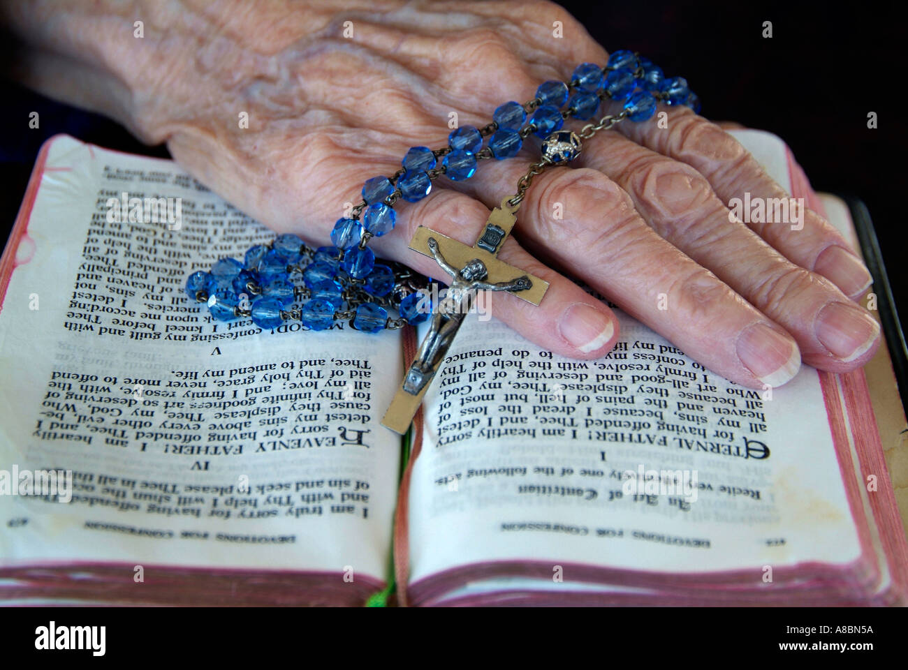 Senior female reading the bible and praying Stock Photo