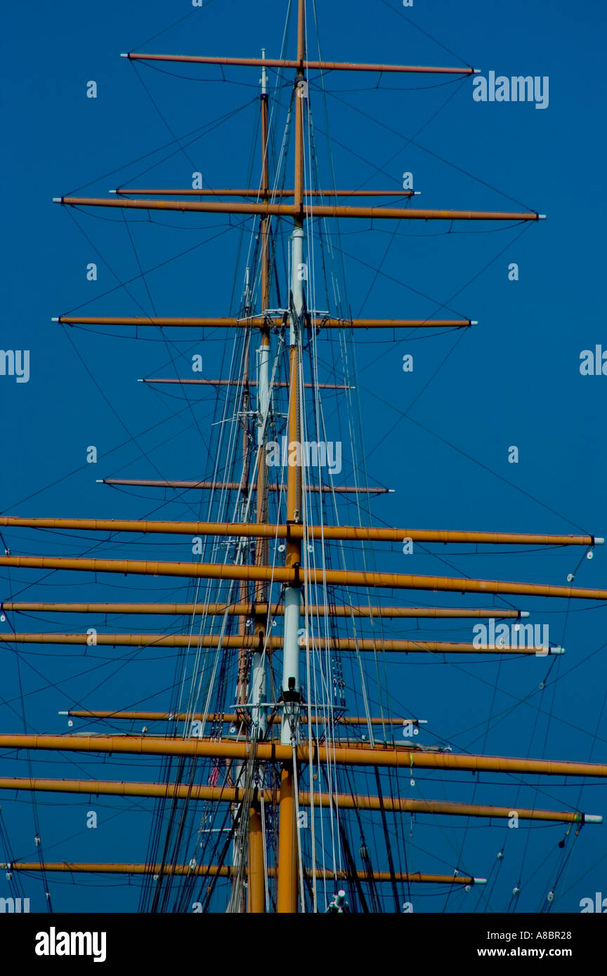 Masts spars and yardarms of historic sailing ship against blue sky