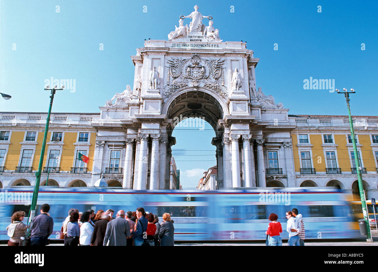 Modern tram passing at Triumph Arch, Comercial Square, Lisbon Europe Stock Photo