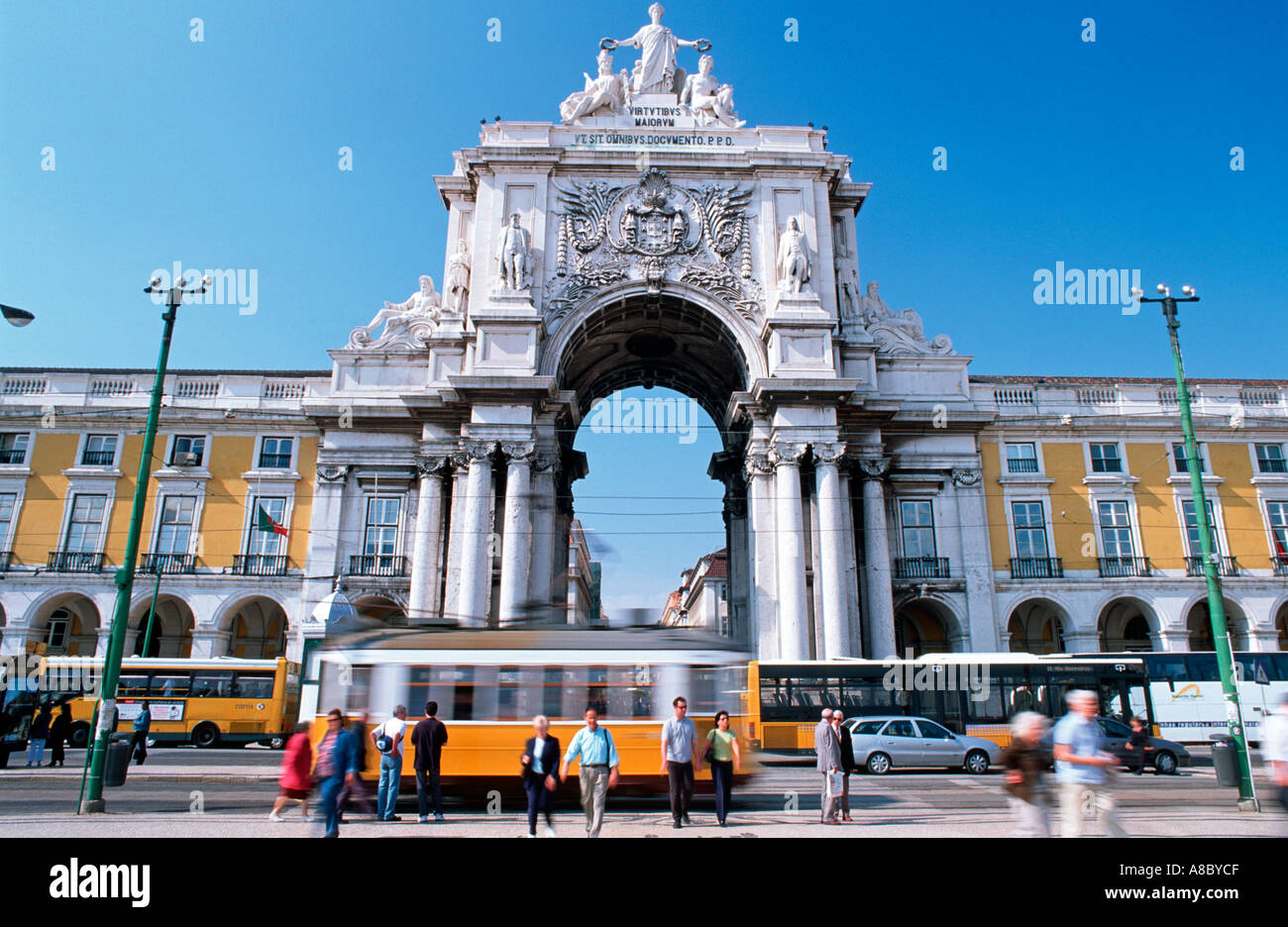 Historical tram passing at Triumph Arch Comercial Square Lisbon Europe Stock Photo