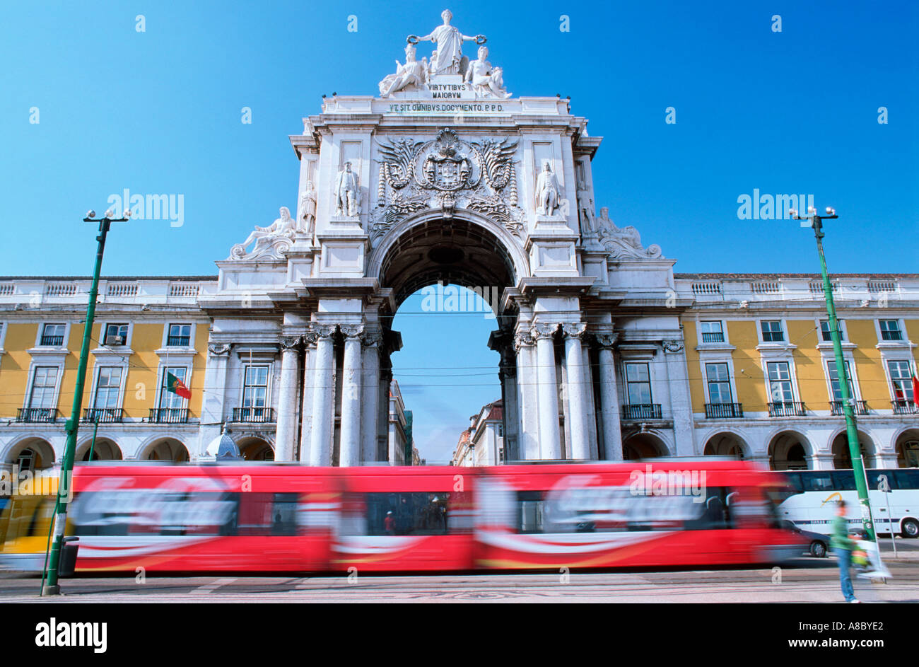 Modern tram passing at Triumph Arch Comercial Square Lisbon Europe Stock Photo