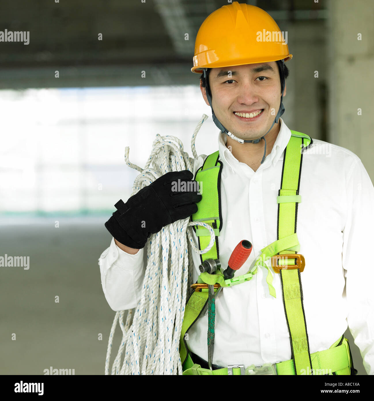 Workers With Ropes at a construction place a worker holding a rope on the shoulder Stock ...
